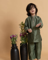 Little boy in a stylish moss green kurta set with delicate embroidery, showcasing festive elegance and comfort. Perfect ethnic wear for kids.